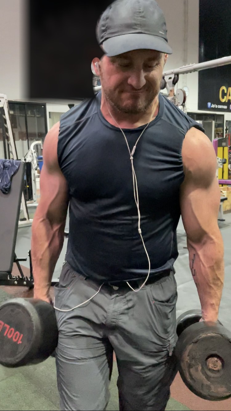 Animal, 50 years old, training with 100 lb dumbbells